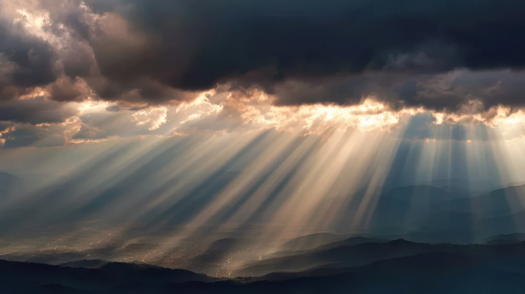 dramatic-sun-rays-breaking-through-dark-clouds-mountains
